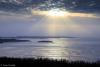 Winter sun rays over Susie Islands. Photo by Travis Novitsky